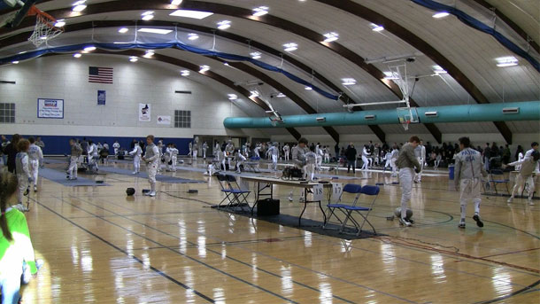 Parent and youth fencer at tournament